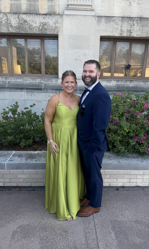 Tara in a green gown and Tyler in a navy suit