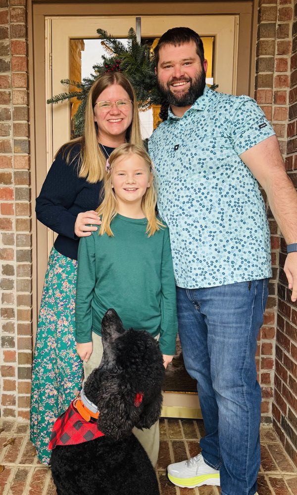 Tara, Tyler, Ivy and their dog on the front porch