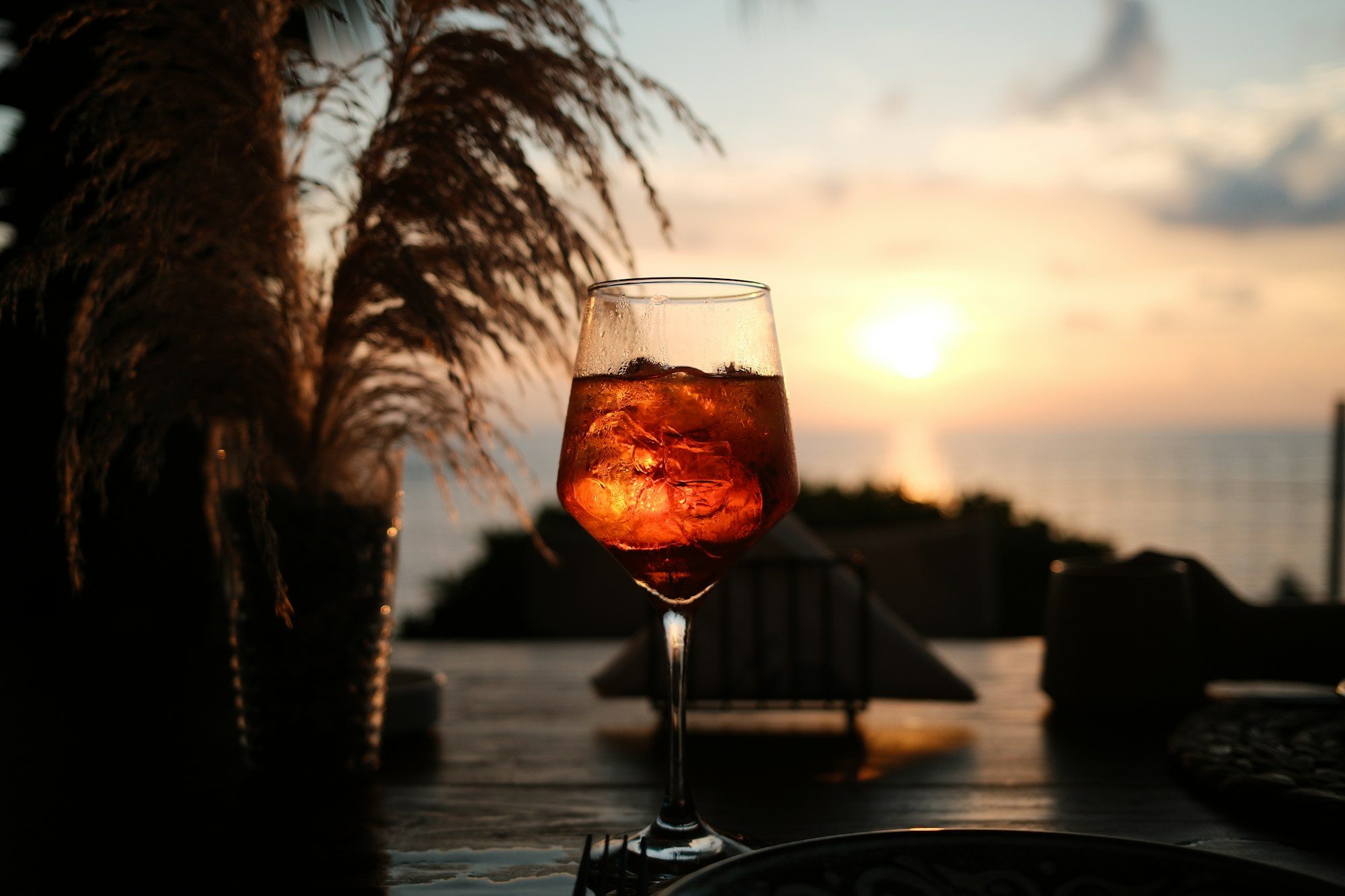 A spritz cocktail at sunset by the sea